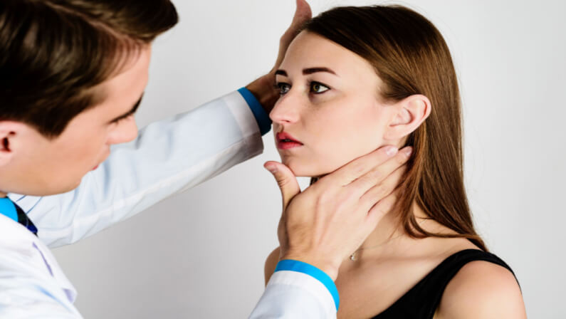 doctor checking patient's jaw