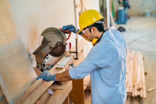 A professional male engineer working on electronic robotic arm welding.