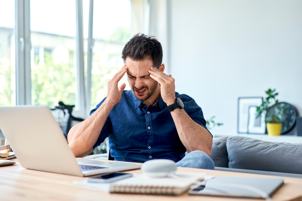 man suffering a serious headache