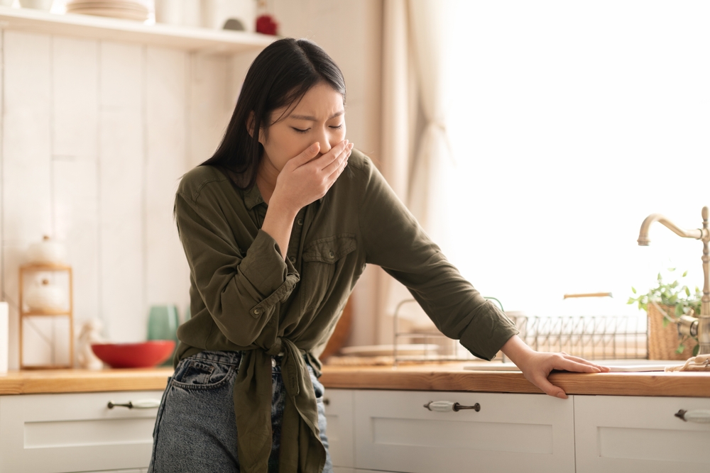 Young Asian Woman In Casual Feeling Nausea and Covering Mouth While Standing