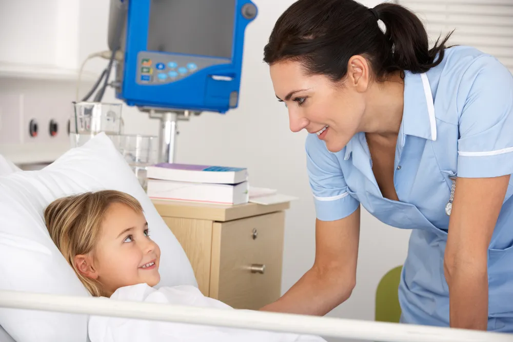 Nurse with child patient in UK Accident and Emergency