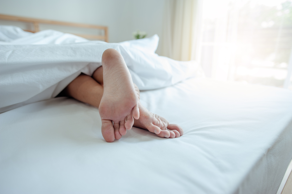 Young female sleeping in bed at home