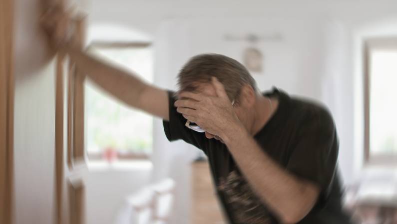 Blurred photo of a man suffering from dizziness or other health problem