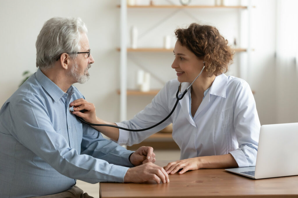 old man having a check up with a female doctor