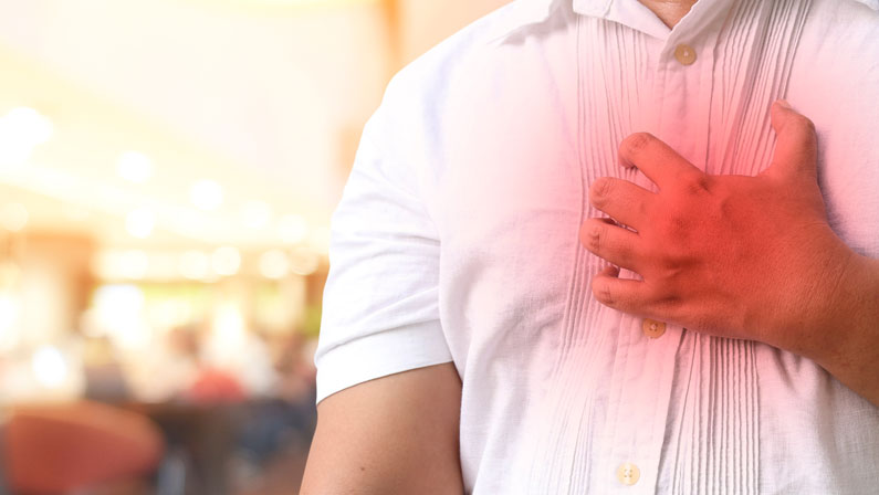 A man holding his chest because of pain.