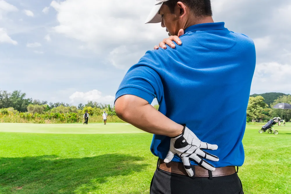 Golfer Back and shoulder pain during the game, muscle injury concept