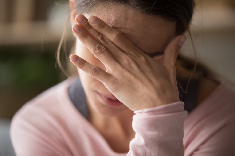 Young Woman Touching Forehead Having Headache