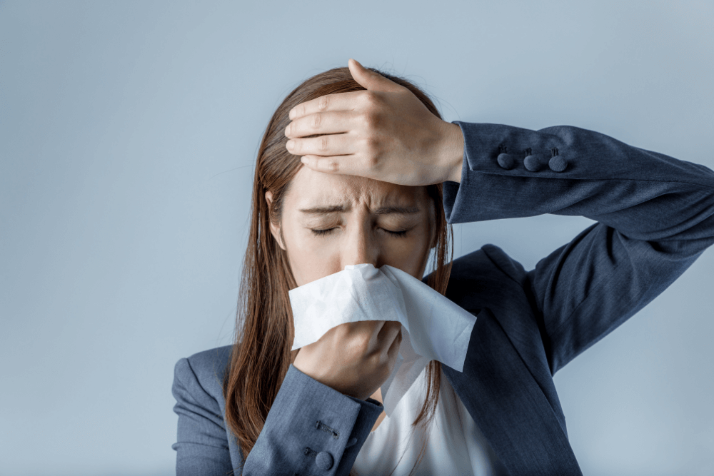 young woman blowing her nose. allergic rhinitis.