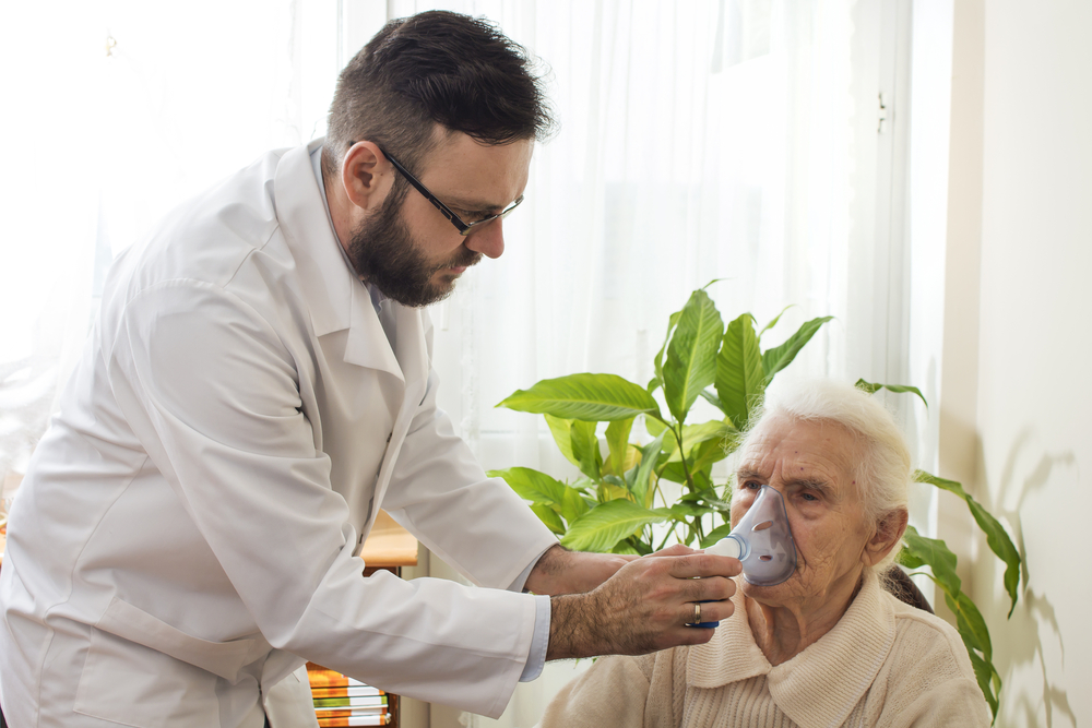 The Doctor Holds Inhaler The Face Of An Old Woman.